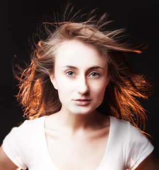 Portrait of a beautiful young woman on a dark background