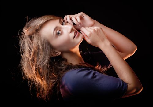 Portrait of a beautiful young woman on a dark background