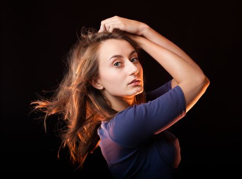 Portrait of a beautiful young woman on a dark background