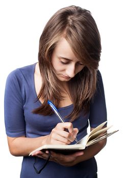 Young woman writing in notebook on a white background