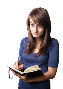 Young woman writing in notebook on a white background