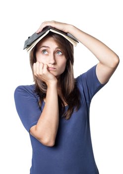 Education. Tired girl holds a notebook on her head on a white background