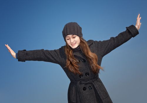 Joyful young woman against blue sky  background