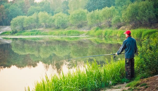 Fisherman Catches Of Salmon On The River Mouth