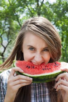 Young woman with watermelon outdoors