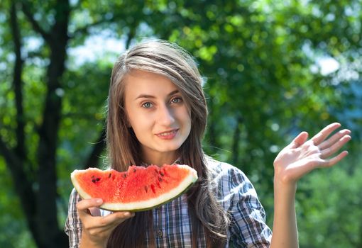 Young woman with watermelon outdoor