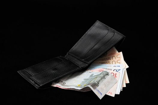 Wallet with euro currency on a dark background