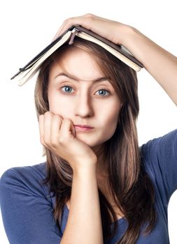 Education. Tired girl holds a notebook on her head on a white background