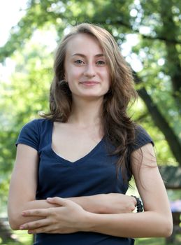 Portrait of a young woman on blured forest background