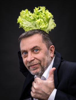 Healthy food. Man holding and eating lettuce
