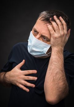 Portrait of sick old man in medical mask