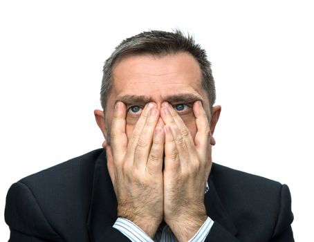 Portrait of an middle age man with face closed by hands. Isolated on white
