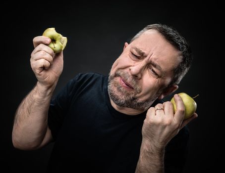 Portrait of a middle-aged man with a green apples