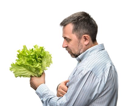 Healthy food. Man holding lettuce isolated on white