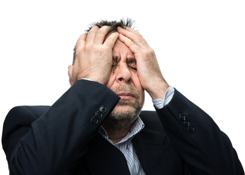 Headache. Portrait of an middle age man with face closed by hands. Isolated on white