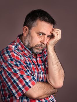 Portrait of a thoughtful elderly man with hand near the face