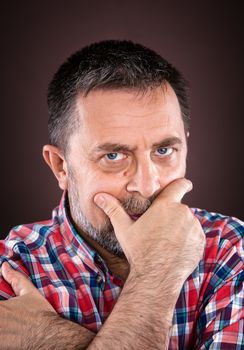 Portrait of a thoughtful elderly man with hand near the face