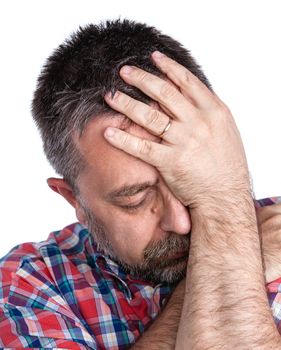 Headache. Portrait of an middle age man with face closed by hand. Isolated on white