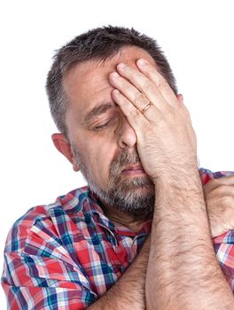 Headache. Portrait of an middle age man with face closed by hand. Isolated on white