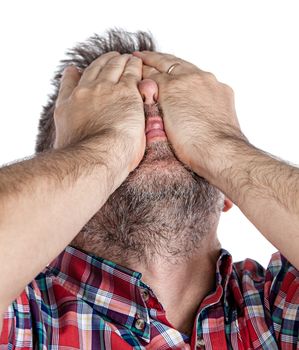 Headache. Portrait of an middle age man with face closed by hand. Isolated on white