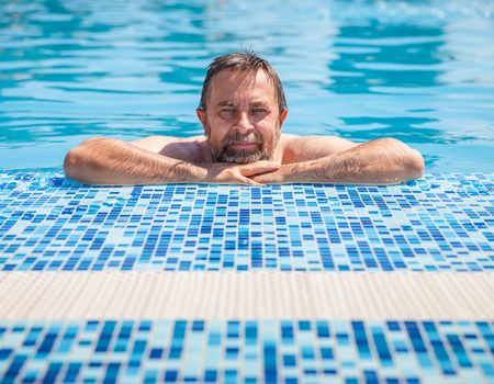 Healthy lifestyle. Middle-aged man in a swimming pool