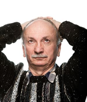 Portrait of an elderly man with hands behind head