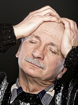  Depression. Elderly man suffering from a headache