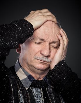 an older man suffering from a headache