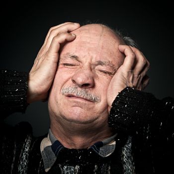 Pain. Elderly man suffering from a headache