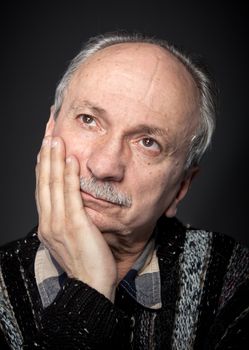 Portrait of handsome senior man with a tired expression