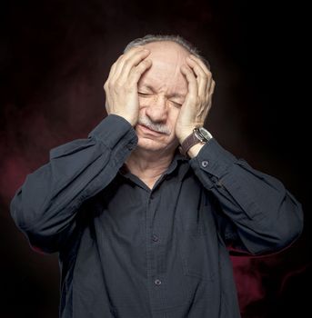 Elderly man suffering from a headache