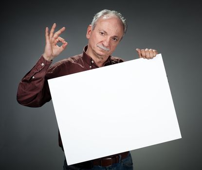 Portrait of a retired old man holding empty bill board