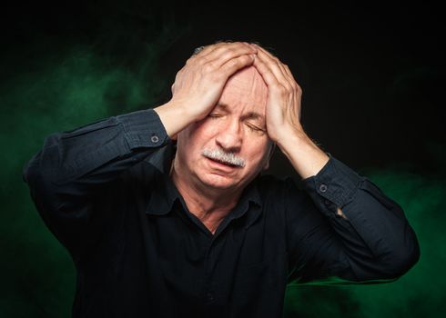 elderly man suffering from a headache