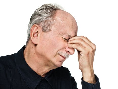 Elderly man suffering from a headache isolated on white