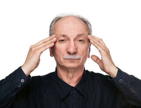 Elderly man suffering from headache and massaging his temples on white background