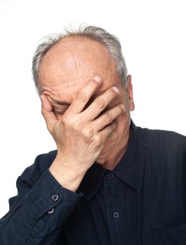 Pain. Elderly man covers his face with hand