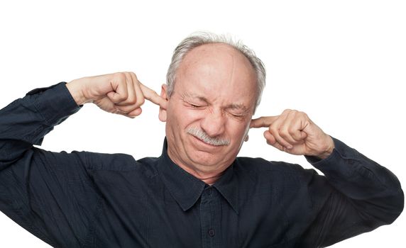 A man covers his ears with his hands. Suffering from a loud sound.