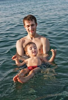 Father teaching his son to swim