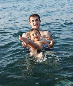 Father teaching his son to swim