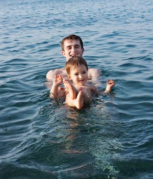 Father teaching his son to swim