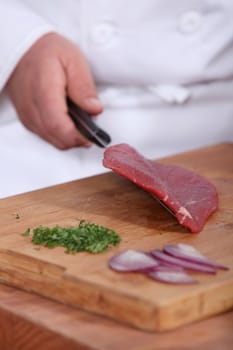 Butcher with raw piece of piece