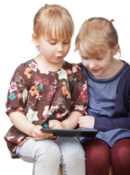 Two little girls using a touch pad