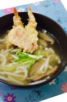 Udon noodles with shrimp tempura in black bowl , Japanese food