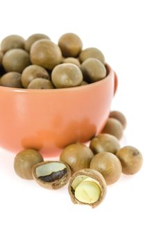 Shelled and unshelled macadamia nuts  in a cup