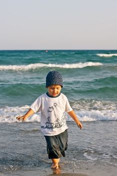 Boy walks on the beach