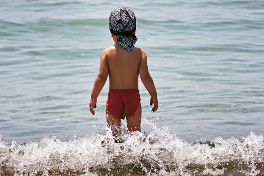 Boy going to sea. Child is going to swim