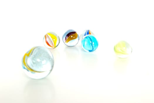Colourful marbles on white background