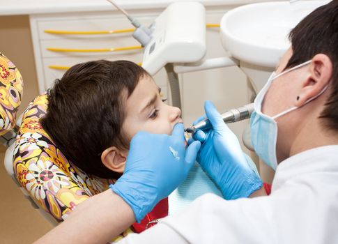  little boy healing his teeth in dentist's office