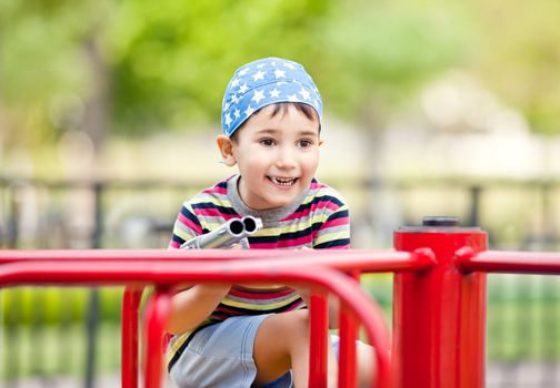 Cute smiling young boy with toy gun