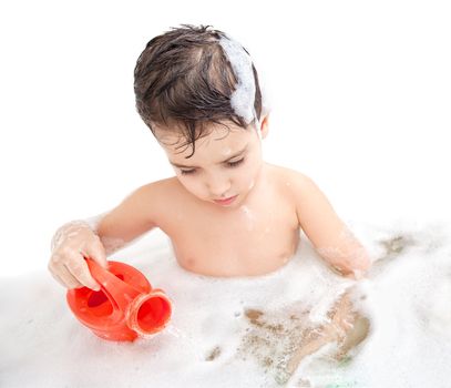 Boy washing in the bathroom and plays with toy